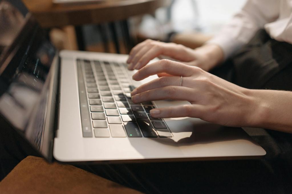 Woman hands typing on a laptop computer